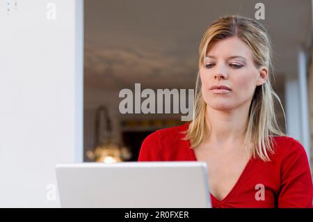 Mid adult woman using a laptop Stock Photo