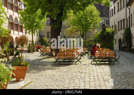 Waitress laying the table at beergarden, Regensburg, Upper Palatinate, Bavaria, Germany Stock Photo