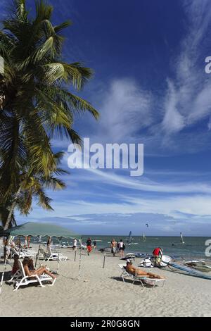 Tourists sunbathing at beach of Playa El Yaque, Isla Margarita, Nueva Esparta, Venezuela Stock Photo