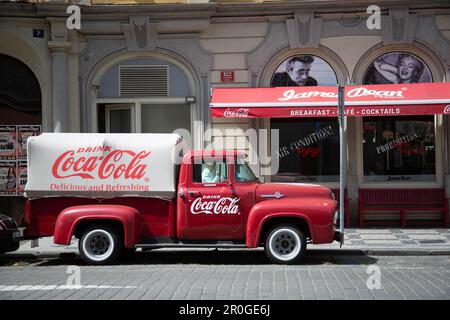 Vintage Coca Cola truck in front of cafe in Prague Stock Photo