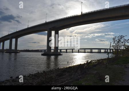 Victory and Driscoll Bridges over the Raritan River on a cloudy spring afternoon, with the setting sun reflecting in the water  -10 Stock Photo