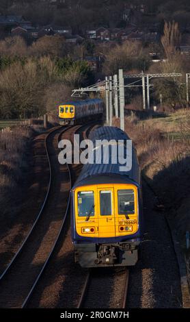 2 Northern Rail class 769 flex bi mode trains passing at Lostock junction, the end of the electrified section while running on diesel. Stock Photo