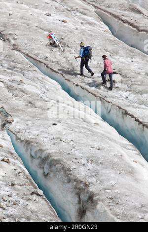 Two hikers on Gorner glacier to Monte Rosa Hut, Zermatt, Canton of Valais, Switzerland, myclimate audio trail Stock Photo