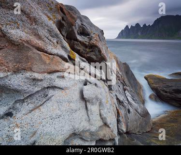 Steep and rugged mountains rising straight from the sea, Erstfjord, Senja island, Troms, Norway Stock Photo