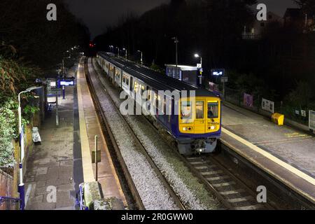 Northern Rail class 769 bi mode flex train 769434 calling at Hindley railway station at night while running on diesel Stock Photo