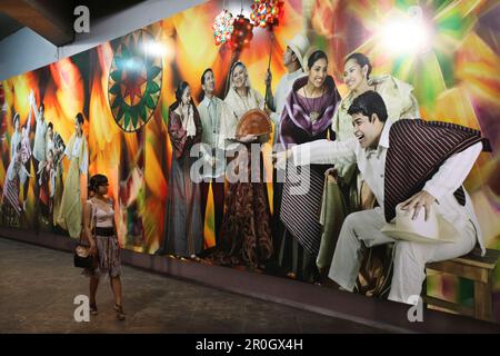 Young woman looking at a wail painting in a tunnel, Makati City, Manila, Luzon Island, Philippines Stock Photo