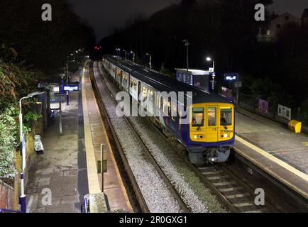 Northern Rail class 769 bi mode flex train 769434 calling at Hindley railway station at night while running on diesel Stock Photo