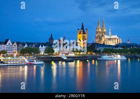 View over the Rhine river to church Groß St. Martin and cathedral in the evening, Cologne, North Rhine-Westphalia, Germany, Europe Stock Photo