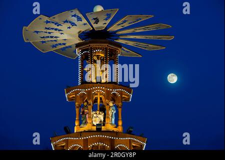 Christmas pyramid with full moon at the Christmas market, Karlsruhe, Baden-Wuerttemberg, Germany Stock Photo