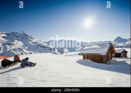 Snowboarders near a mountain hut, Tignes, Val d Isere, Savoie department, Rhone-Alpes, France Stock Photo