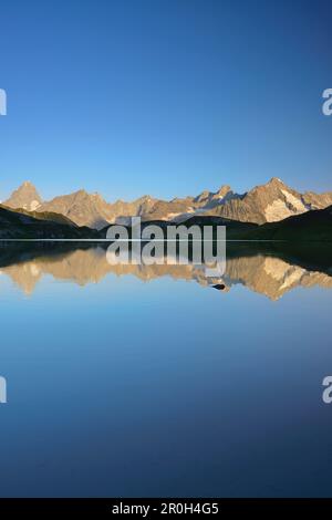 Mont Blanc range with Grandes Jorasses and Mont Dolent reflecting in a mountain lake, Pennine Alps, Aosta valley, Italy Stock Photo