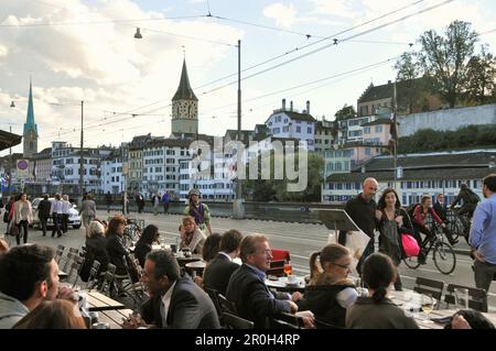 People at a street cafe in front of the town hall at Limmat river, Zurich, Switzerland, Europe Stock Photo