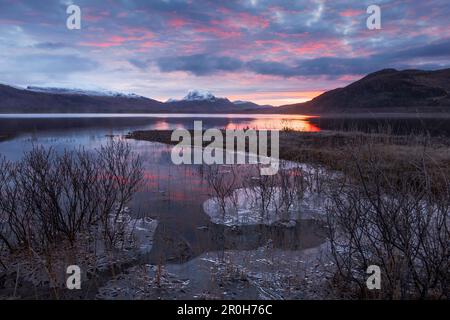 Sunrise above the Northwest Highlands with the wide view over Loch Maree in winter, Scotland, United Kingdom Stock Photo