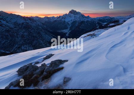 Sunset with snow structures on the plateau of Monte Piano, looking west to the Dolomiti di Braies, Sexten Dolomites, South Tyrol, Italy Stock Photo