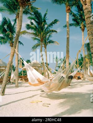 MEXICO, Maya Riviera, couple in a hammock relaxing, Xcaret Stock Photo