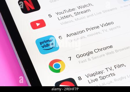 Disney+, Netflix, Youtube and Amazon Prime Video apps seen in App Store on the screen of ipad. The most popular apps chart. Selective focus. Stafford, Stock Photo