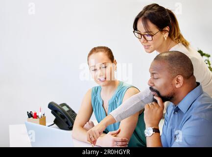 What is your plan with this. a diverse group of businesspeople brainstorming while using a laptop in the office. Stock Photo