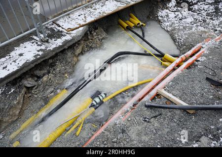 Workplace with frozen underground pipes and cables during wintertime Stock Photo