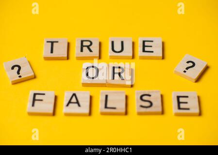 True or false words on a yellow background with a question mark. Choice concept. Stock Photo