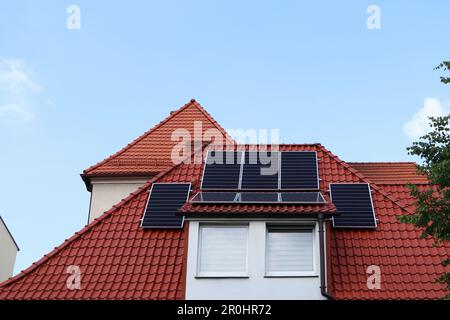 House with installed solar panels on roof Stock Photo