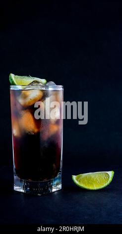 Cuba Libre drink on black background with copy or text space Stock Photo