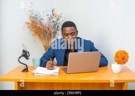 Happy african american businessman entrepreneur startup owner stand in modern office looking at camera Stock Photo