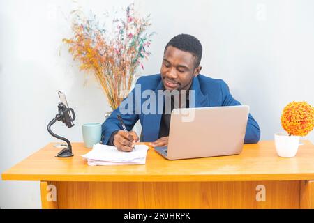 Happy african american businessman entrepreneur startup owner stand in modern office looking at camera Stock Photo