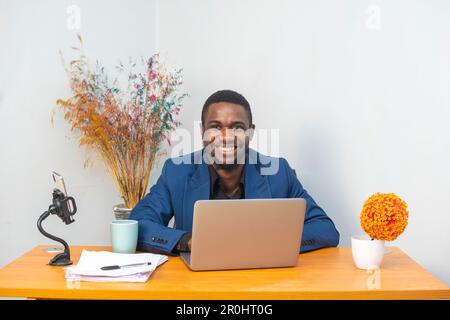 Modern Office: Portrait of Stylish Hispanic Businessman Works on Laptop, Does Data Analysis and Creative Designer Stock Photo