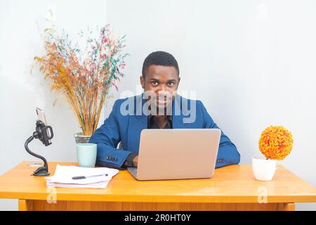 Modern Office: Portrait of Stylish Hispanic Businessman Works on Laptop, Does Data Analysis and Creative Designer Stock Photo
