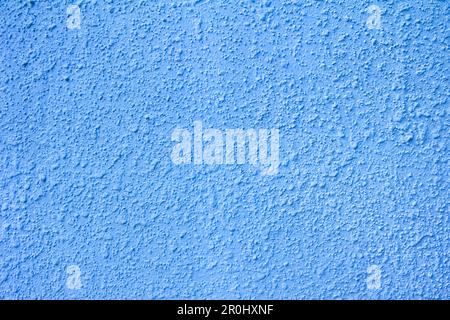 Blue painted plaster rough wall. Grunge abstract pastel trextured background for design. Close up photo Stock Photo