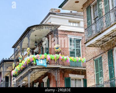 NEW ORLEANS, LA, USA - APRIL 16, 2023: French Quarter gallery decorated for French Quarter Festival with bubble machine blowing bubbles Stock Photo