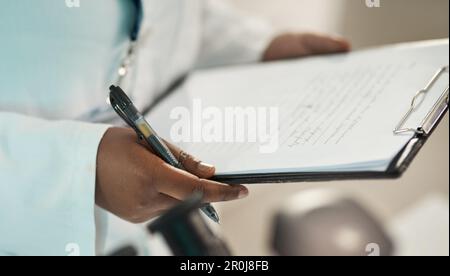 Writing up a few reports. Closeup shot of an unrecognisable scientist holding a clipboard in a lab. Stock Photo
