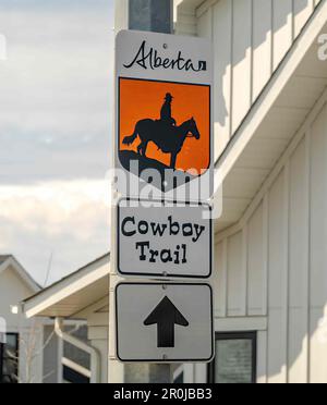 Okotoks, Alberta, Canada. May 7, 2023. A sign to The Cowboy Trail, a narrow band of mixed forests and grasslands, a wide variety of wildlife species a Stock Photo