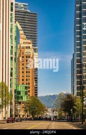 The downtown Vancouver with busy streets and modern cars, tall ...