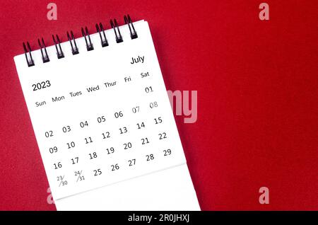 July 2023 Monthly desk calendar for 2023 year on red background. Stock Photo