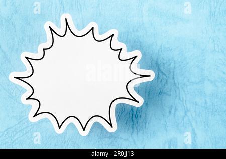 Blank white speech bubble isolated on blue background. Stock Photo