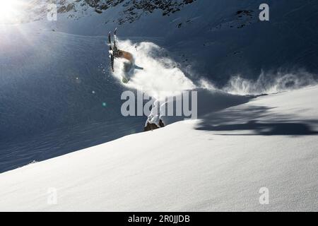 Young male skier doing a backflip over a rock, Pitztal, Tyrol, Austria Stock Photo