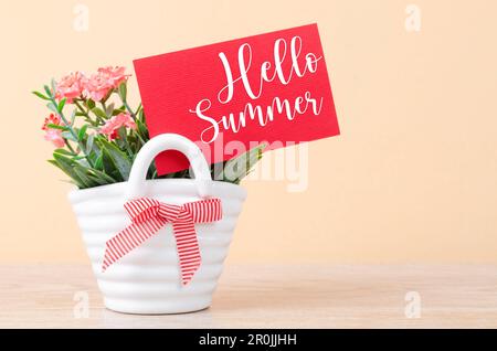 Hello summer on red card with flowers bouquet in vase. Stock Photo