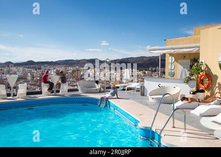 People relax at rooftop swimming pool of AC Hotel Malaga Palacio by Marriott, Malaga, Costa del Sol, Andalusia, Spain Stock Photo