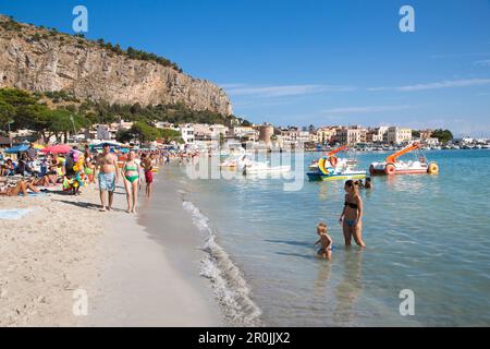 People enjoy sunny Sunday morning at Mondello beach, Mondello, near Palermo, Sicily, Italy Stock Photo