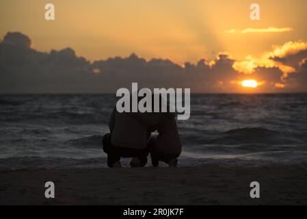 Couple making a selfie at the Baltic beach in the evening atmosphere in the Western Pomerania Lagoon Area National Park, Dierhagen, Fischland-Darss-Zi Stock Photo