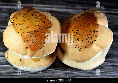 Egyptian Mahlab bread, puff thin, crispy and delicious with black seed baraka seeds on top, made of flour, dry yeast, milk, eggs, sugar, salt, black s Stock Photo