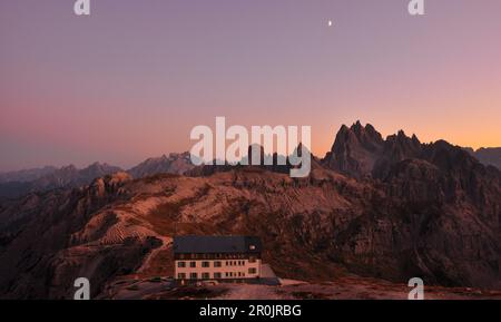 hut Rifugio Auronzo and peaks of Cadini di Misurina after sunset with moon, Val Pusteria Valley, Sesto, Dolomites, South Tyrol, Veneto, Alto Adige, Th Stock Photo