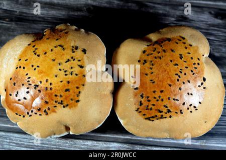 Egyptian Mahlab bread, puff thin, crispy and delicious with black seed baraka seeds on top, made of flour, dry yeast, milk, eggs, sugar, salt, black s Stock Photo