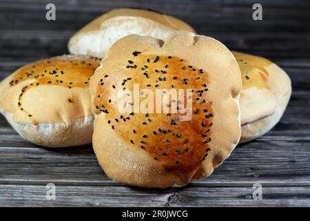 Egyptian Mahlab bread, puff thin, crispy and delicious with black seed baraka seeds on top, made of flour, dry yeast, milk, eggs, sugar, salt, black s Stock Photo