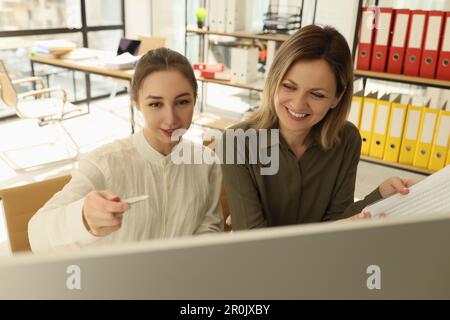 Smiling colleagues discussing new start-up in office Stock Photo