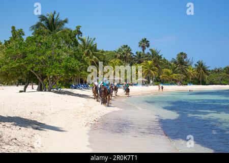 Half Moon Resort horseback ride excursion along Sunrise Beach and in Caribbean Sea Rose Hall, near Montego Bay, Saint James, Jamaica Stock Photo