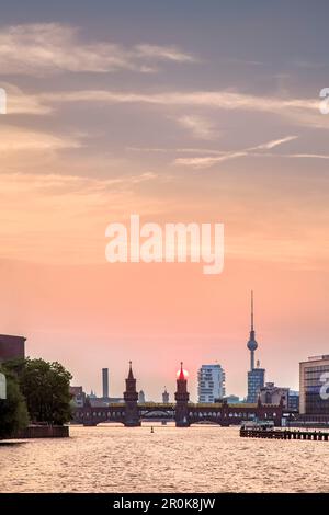 Sunset over the River Spree, view toward Oberbaum bridge and TV tower, Kreuzberg, Berlin, Germany Stock Photo