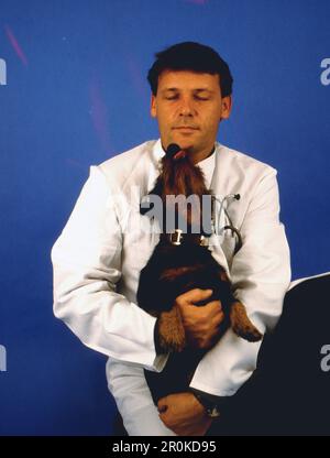 Walter Plathe, deutscher Schauspieler, hier in seiner Rolle als Dr. Ulli Teschner mit Dackel in der Fernsehserie: Der Landarzt, Deutschland, 1992. Stock Photo