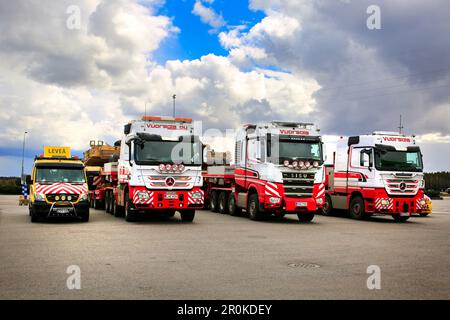 Convoy of three exceptional load transports of US Army M1 Abrams tanks parked at a truck stop yard. Aura, Finland. April 28, 2023. Stock Photo